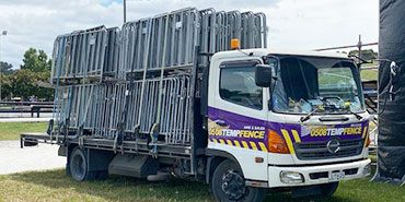 a-truck-carries-crowd-control-barriers